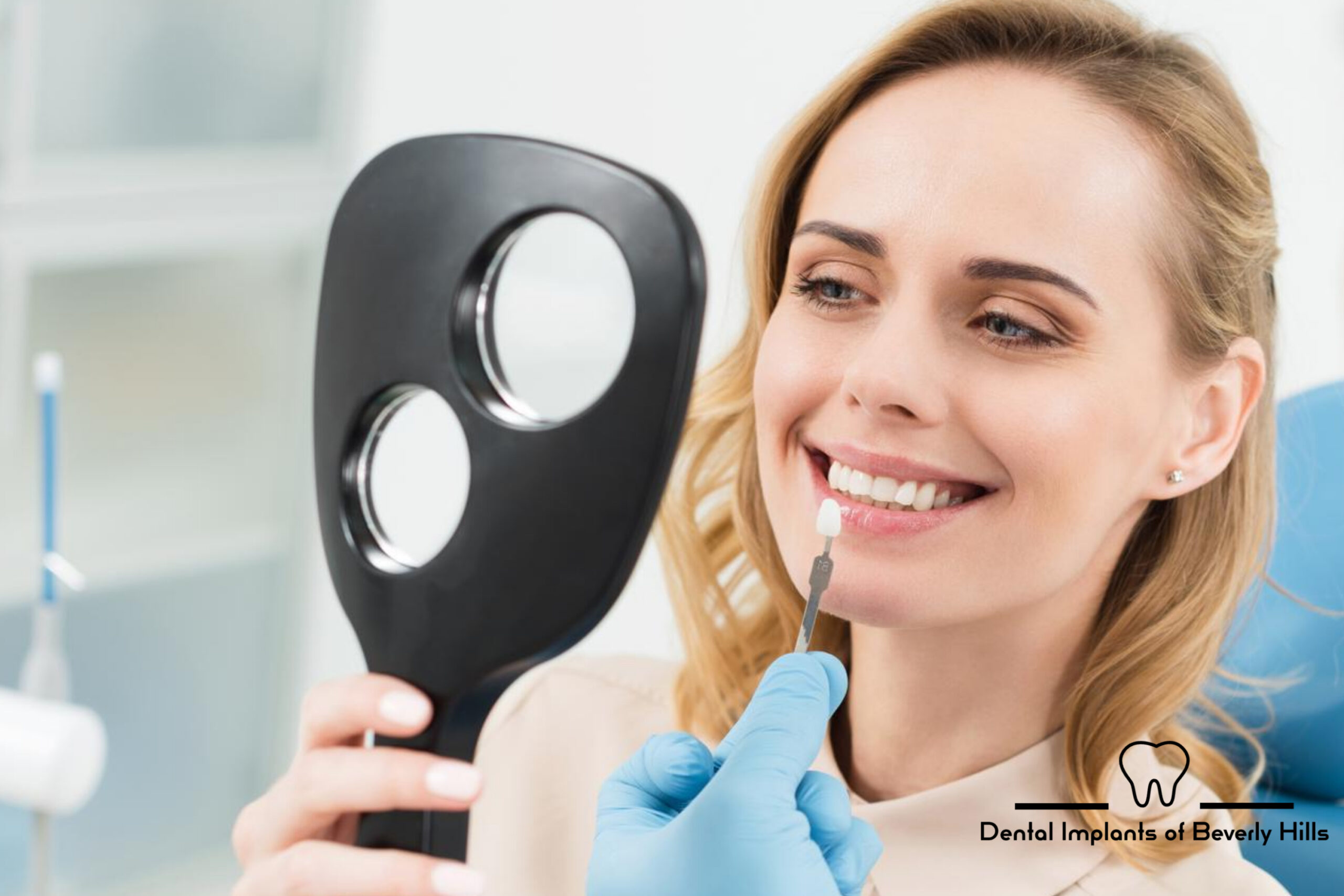 woman smiling looking at color matched dental implant